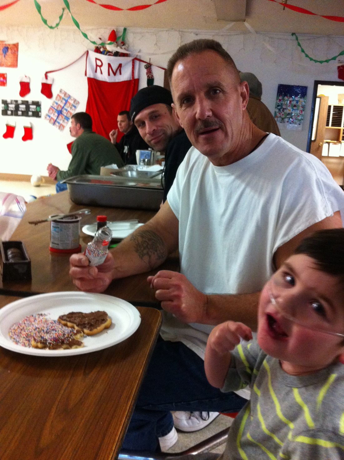 Rudy and friends decorating Christmas cookies at the Rescue Mission.