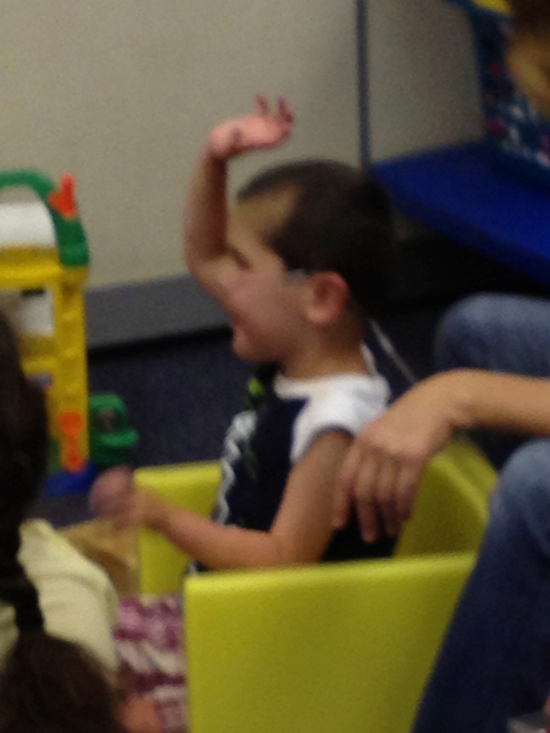 Rudy politely raising his hand and waiting his turn to lead a song during circle time!