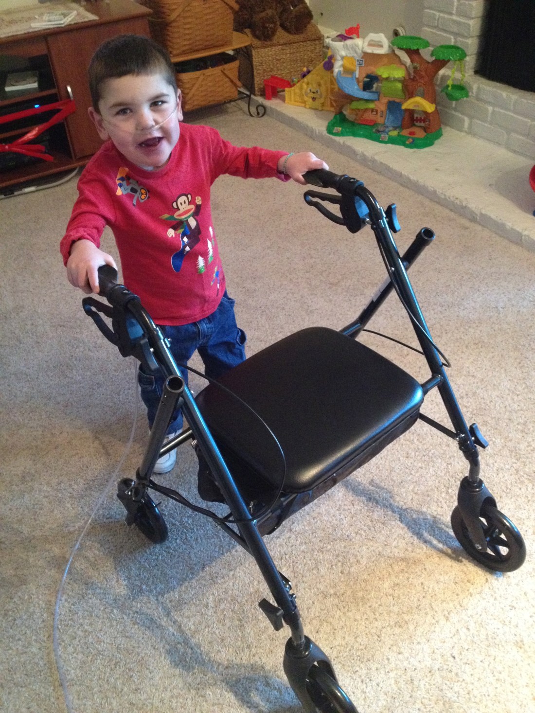 Rudy's "official" Rifton walker doesn't fit through the door frames in our house so we got him a "grown up" walker that he can easily navigate inside!!  He's quick to pull up and go, go, go.  There may be a few more nicks in our baseboards before he masters it but I kinda like the "distressed" look in woodwork.  Ha Ha