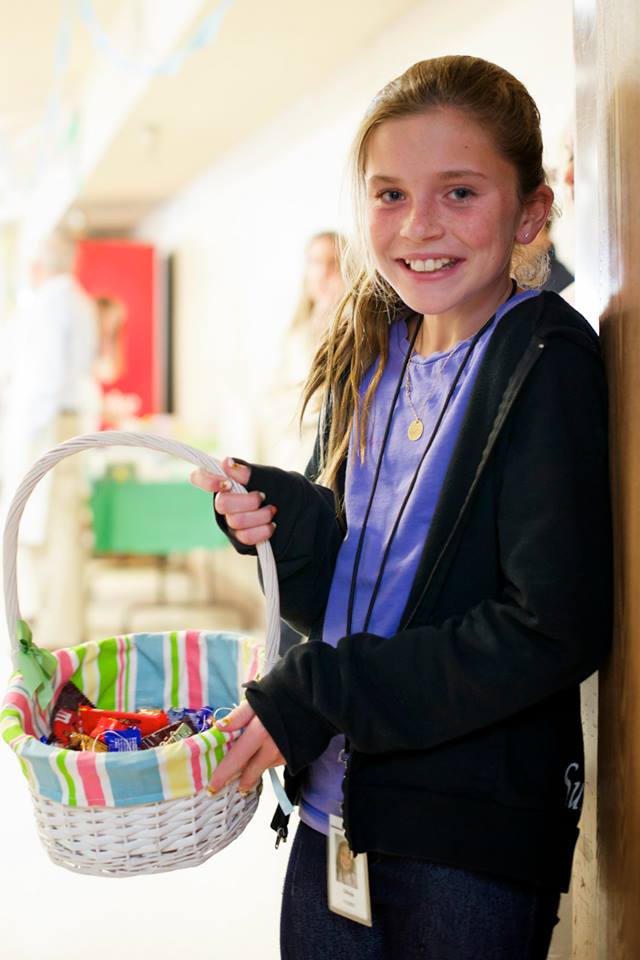 Our Olivia greeting guests with a sweet treat!