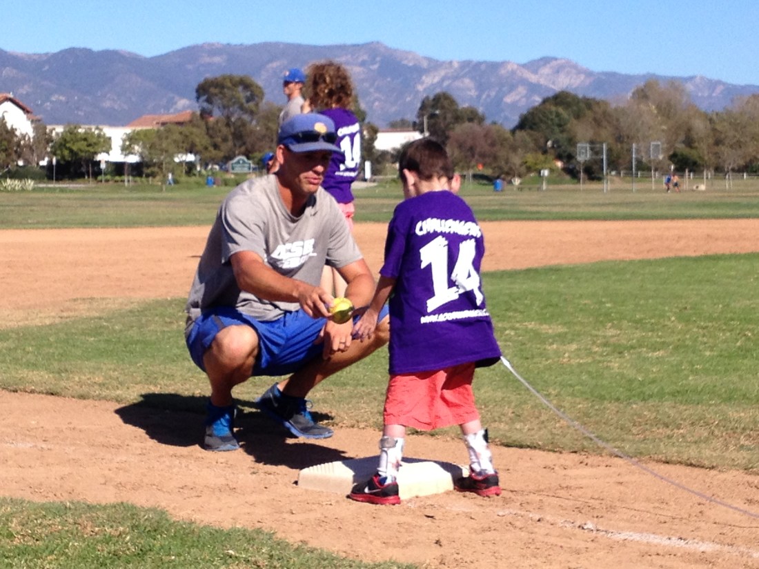 Rudy getting a few pointers on catching and ...