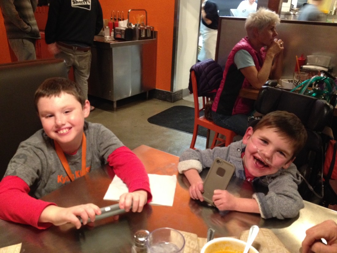 Our new favorite hang out in town is Kyle's Kitchen…you should come visit us and we'll take you there.  Kyle (pictured here with Rudy) is a buddy from school.  His parents (successful restauranteurs here in town) opened this burger joint in Kyle's honor…every month they highlight a different local special needs program or organization and donate a portion of their proceeds to that organization!  Love this sweet family…Love Kyle…LOVE the food!!!  
