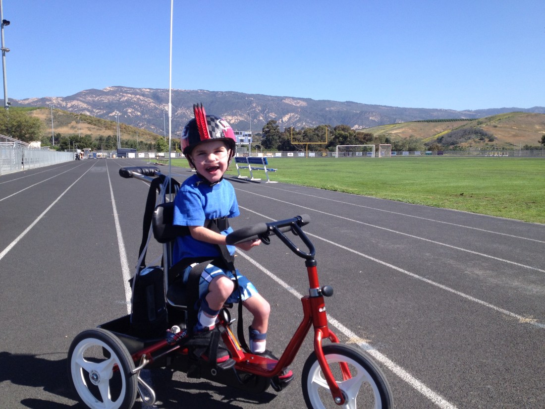 It didn't take long for Rudy to master peddling AND stirring!  He made his way around the high school track TWICE - a 1/2 mile - on his third venture out on his custom trike.  Amazing!!!